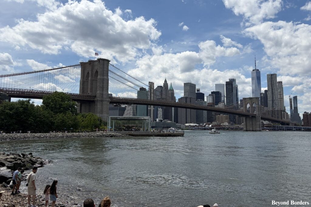The Brooklyn Bridge and Manhattan's Financial District seen from Pebble Beach in DUMBO, Brooklyn in NYC