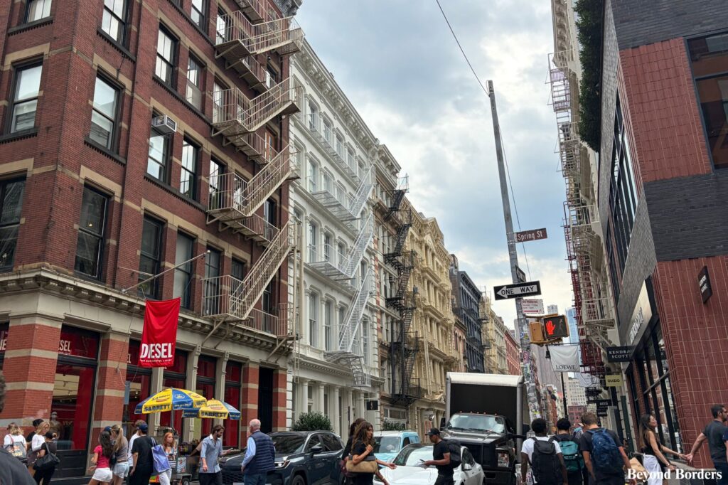 The intersection of Greene St and Spring St in SoHo, NYC with cast-iron architecture