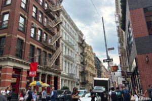 The intersection of Greene St and Spring St in SoHo, NYC with cast-iron architecture