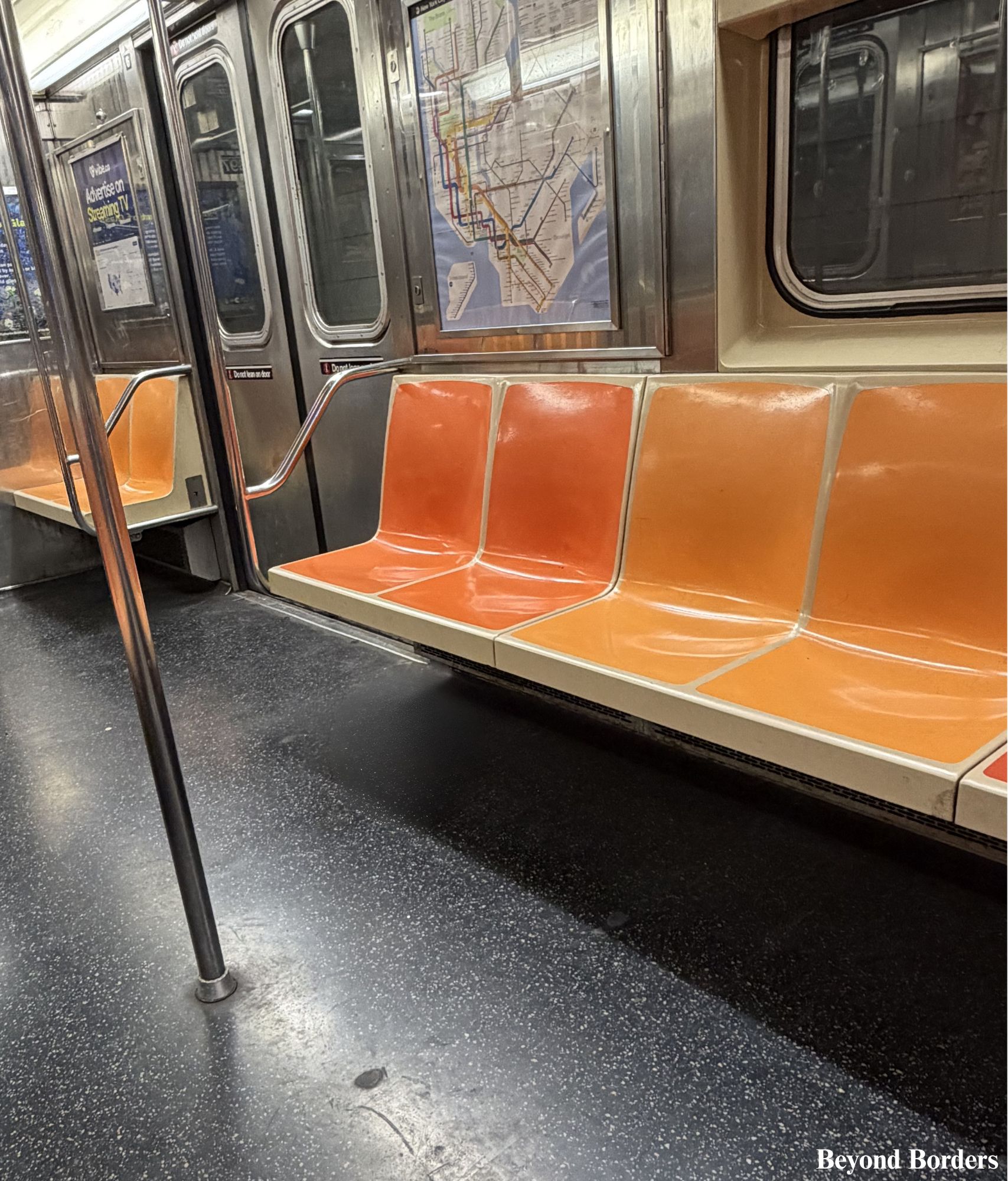 Interior of a NYC subway car with a map on the wall