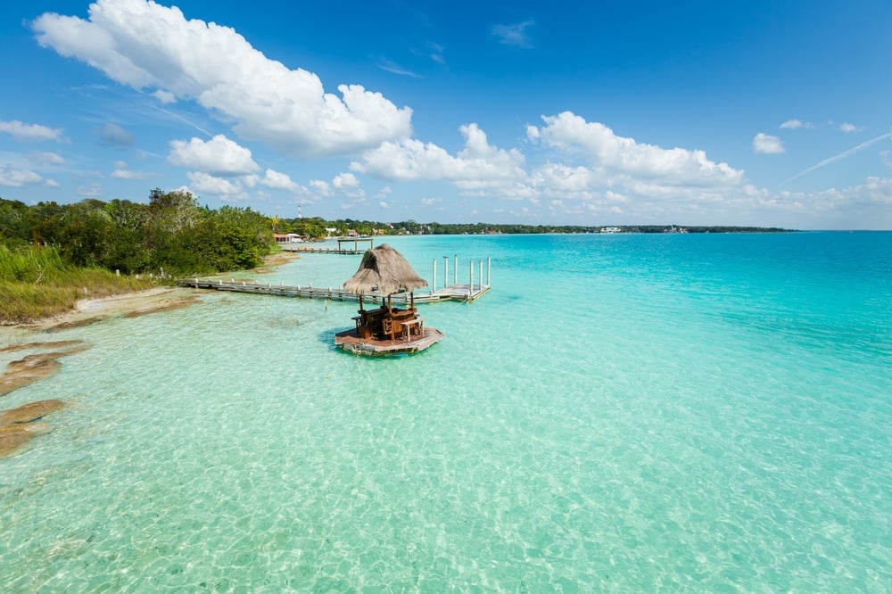 Is this the Maldives of Mexico? Bacalar is home to the stunning "Lagoon of Seven Colors." With the Tren Maya now open, it's the perfect 2026 sustainable escape. Kayak through crystal-clear water and stay in eco-chic overwater bungalows. #Bacalar #LagunaDeSieteColores #MexicoHiddenGems