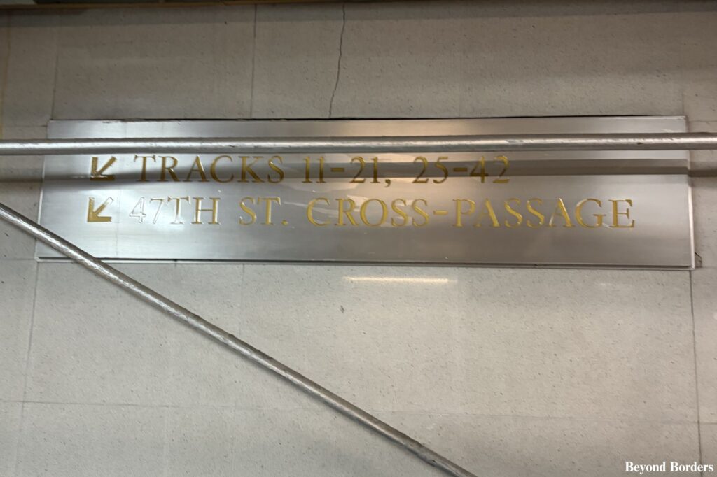 47th Street cross passageway and an escalator going down in the Grand Central tunnel