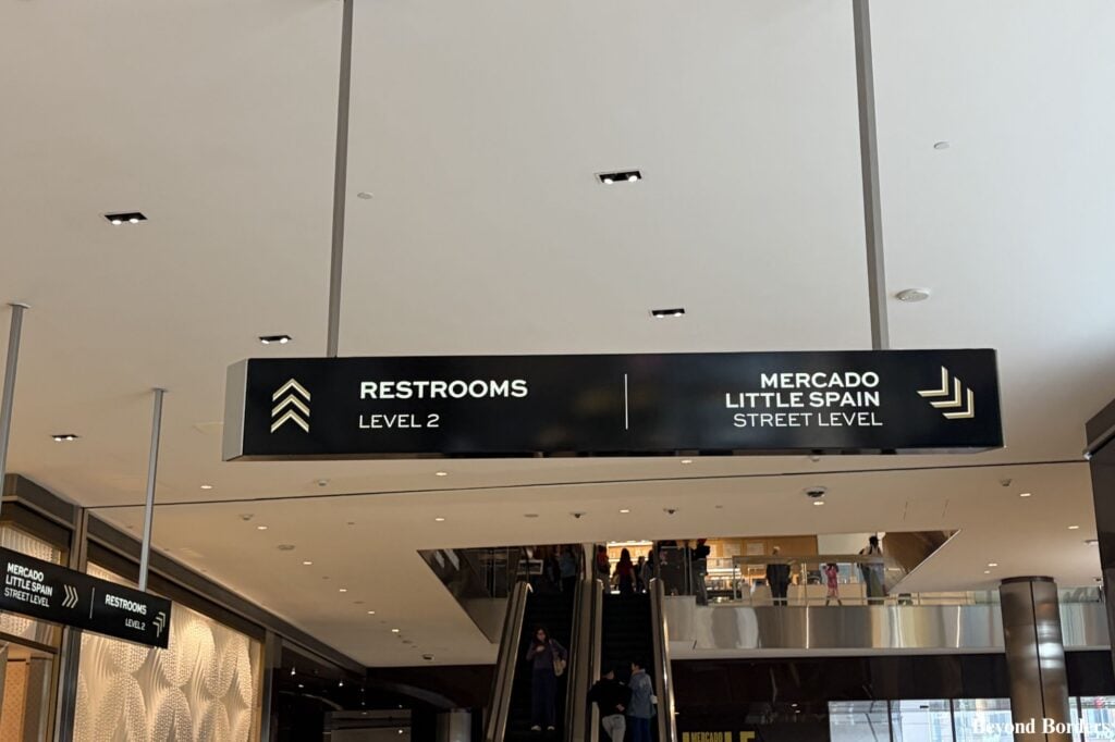 As you walk into the Shops at Hudson Yards, you will see a sign for restrooms on your right.