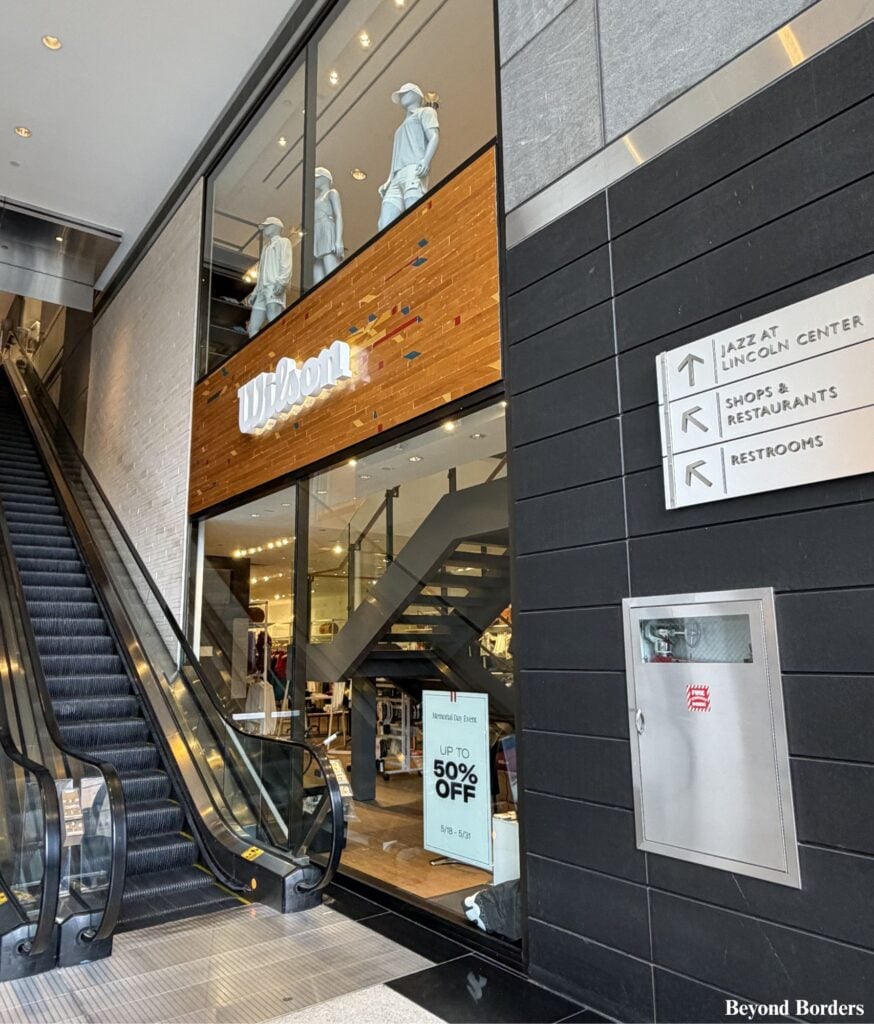 After walking farther into the Shops at Columbus Circle in NYC, you will see escalators with signs to go upstairs to the restrooms.