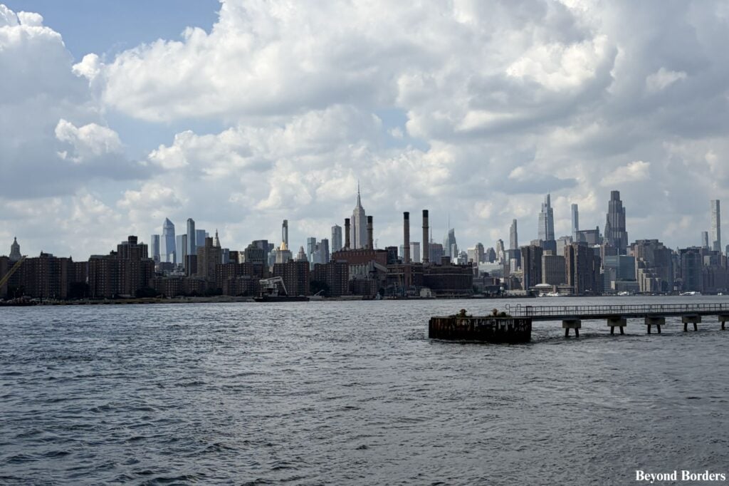 The Midtown Manhattan skyline with the Empire State Building in the center, seen from Domino Park in Williamsburg, Brooklyn, NYC