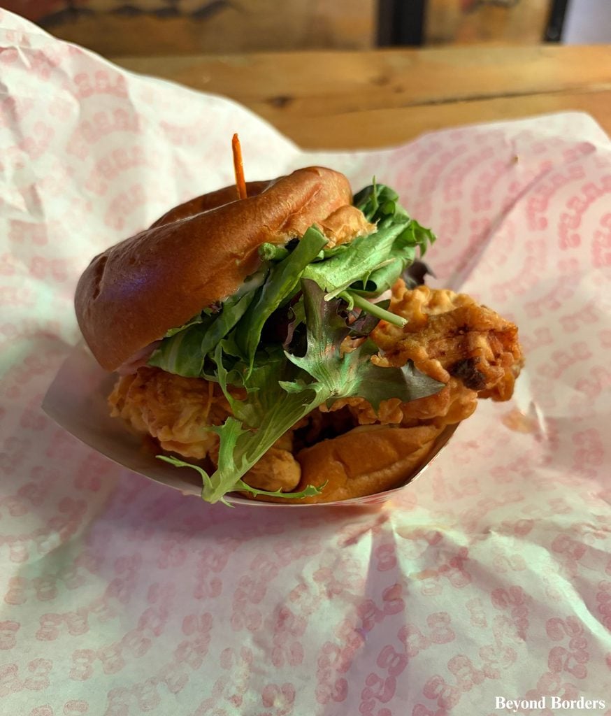 Fried chicken bun on a brioche roll from Baby's Buns and Buckets, DeKalb Market Hall in Brooklyn, NYC