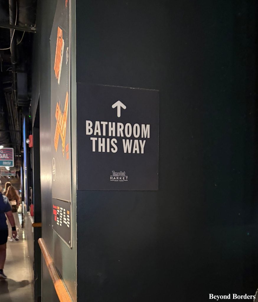 Sign for restrooms on the first floor at Time Out Market in DUMBO, Brooklyn, NYC