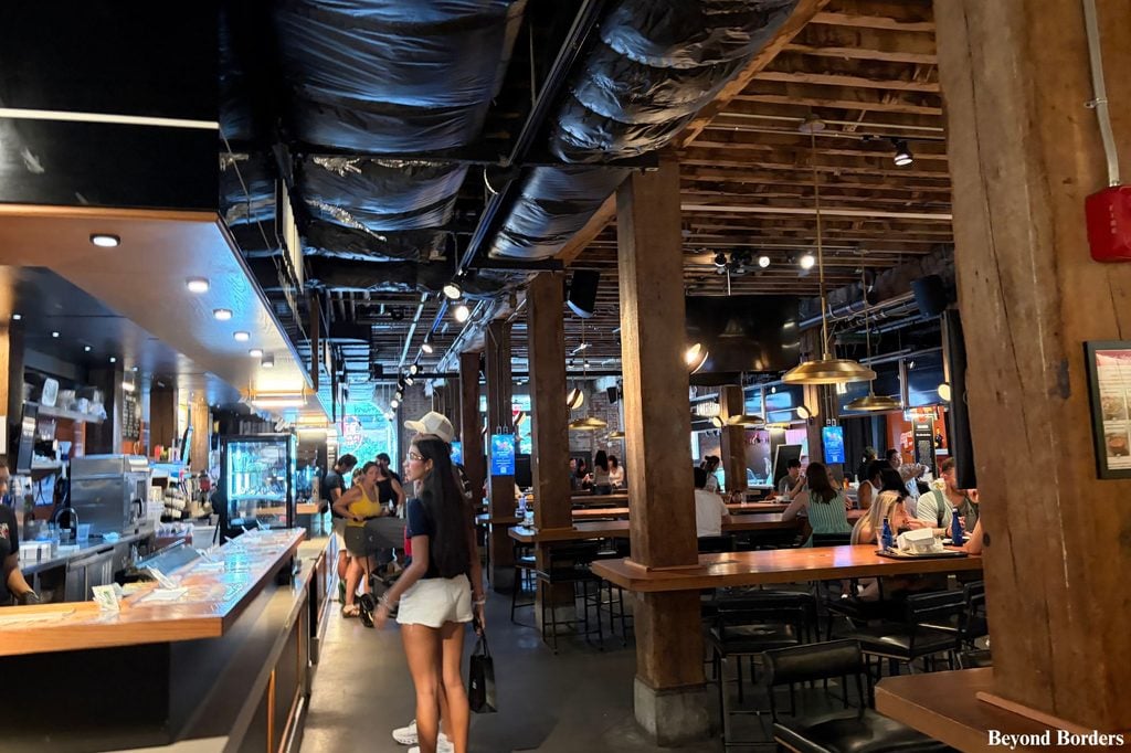 Seating at communal tables in Time Out Market in DUMBO, Brooklyn, NYC