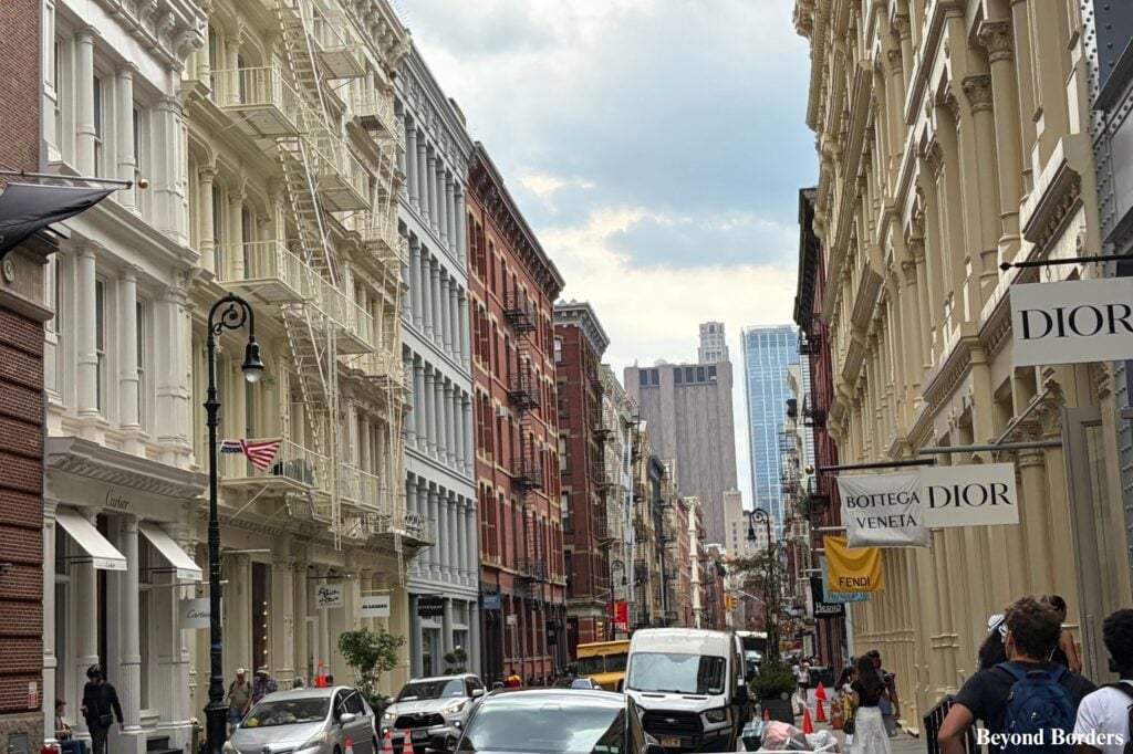 Historic cast-iron buildings, boutique shops, and cobblestones looking north along Greene Street in SoHo, Manhattan, New York City