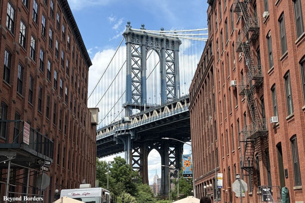Manhattan Bridge framed by historic brick buildings on Washington Street in DUMBO, Brooklyn, NYC; NYC best architectural photo spots