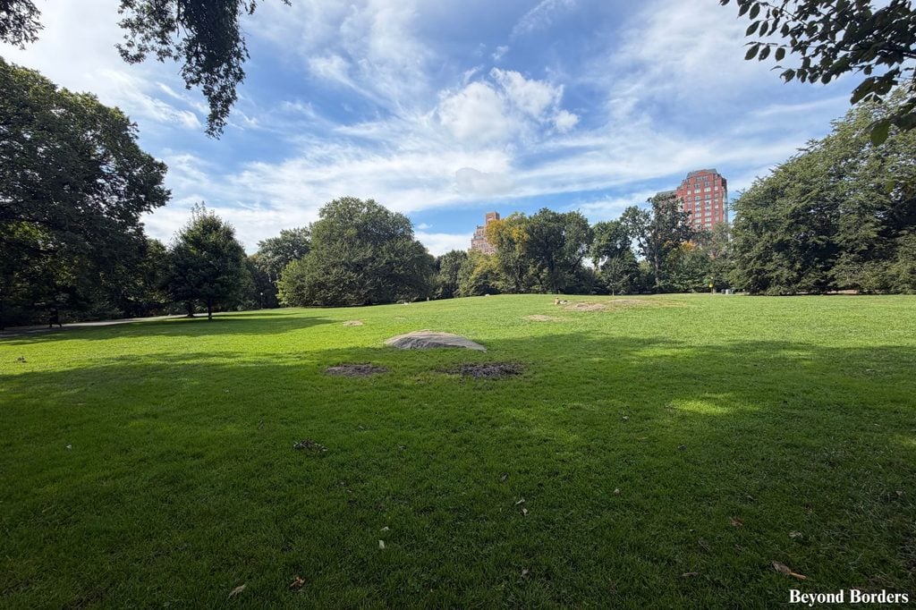 Central Park's Great Hill in the north end with benches and picnic tables surrounding it in Manhattan, NYC; quiet spots in Central Park
